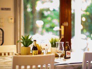 A table with a bottle of beer, a glass, and a potted plant. - Cozy Chalet With Sauna in Lanaken (Lanaken)
