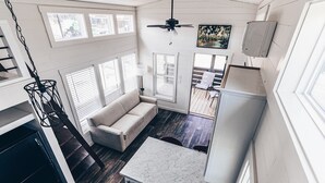 A modern kitchen with a marble countertop, a built-in dishwasher, and a ceiling fan. - Cincinnati Camp Cedar (Mason)