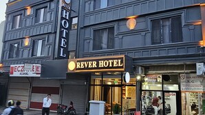 A hotel with a prominent sign reading "REVER HOTEL" and a storefront with a sign for "KUAFOR HAKAN". - Rever Hotel (Sanliurfa)