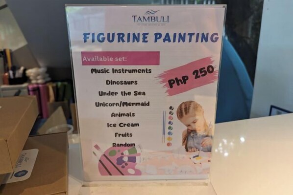 A sign for 'Figurine Painting' with a price of PHP 250. - Studio for 5 at Tambuli Residences Garden View by Dominik Studio with Pool & Balcony in Mactan (Lapu-Lapu City)