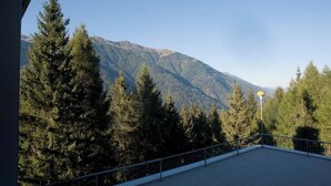 A balcony with a view of a forested mountain range. - Ale 1206 Marilleva 1400, Direct access to slopes  (Marilleva 1400)