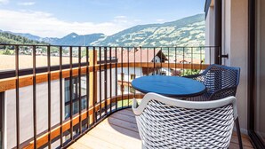 A balcony with a view of mountains and a distant village. - Modern Holiday Apartment With Balcony in Fugen (Fuegen)