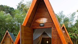 A triangular wooden structure with a bed, a chair, and a small table. - Slumber Resort Koh Chang (Ko Chang)