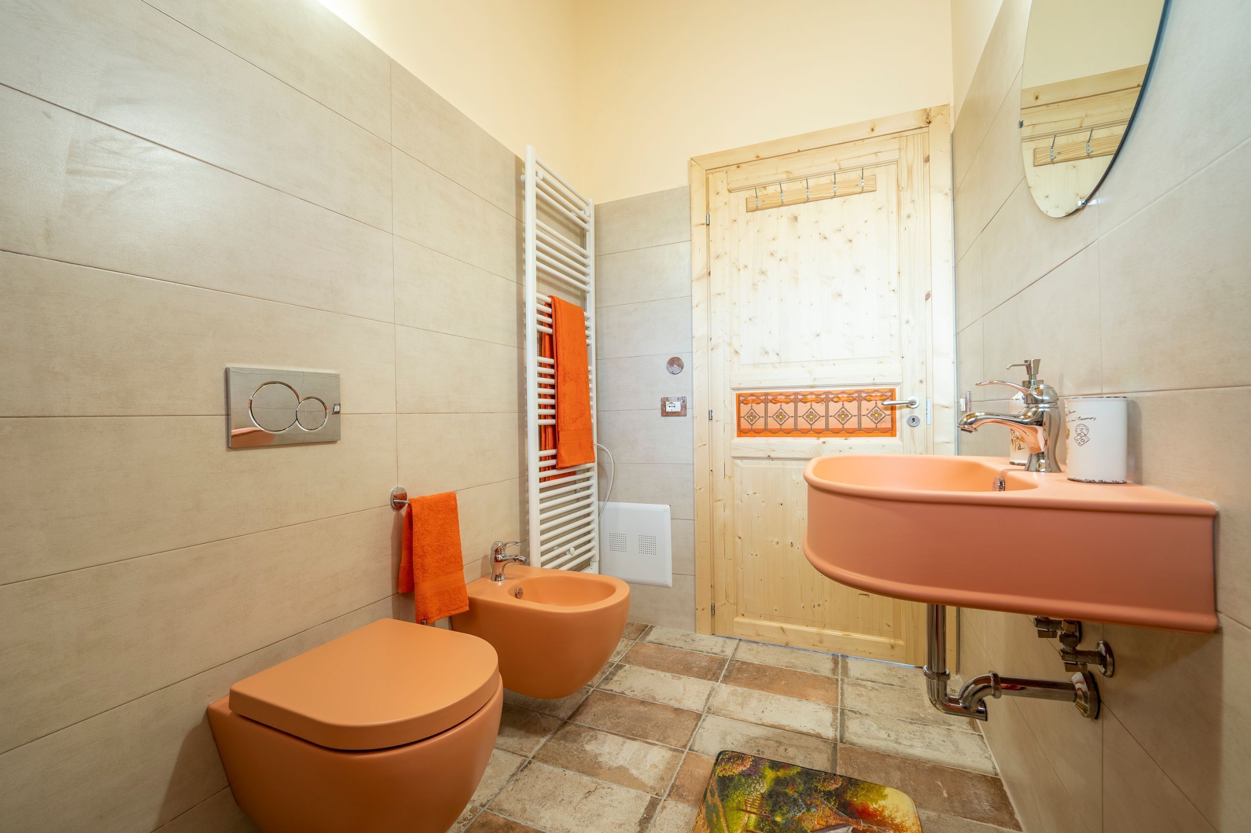 A bathroom with a toilet, bidet, and sink.