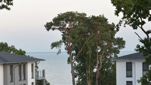 Ein modernes Gebäude mit flachem Dach, großen Fenstern und Meerblick.