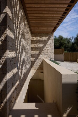 A building with a stone facade and a wooden overhang.