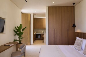 A modern bedroom with a bed, bedside table, chair, and a potted plant. - Valerozo Villa Maestosa - Pool, Jacuzzi & steps to the beach (Ionian Islands, Zakynthos)