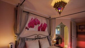 A bedroom with a bed, curtains, a nightstand, a lamp, and a chandelier. - Very Nice Manor House in North African Atmosphere (Kortrijk)