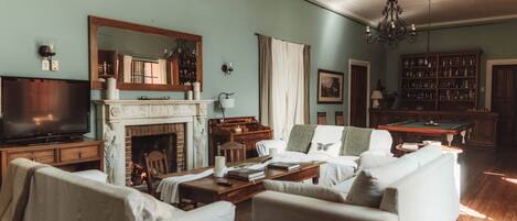 A living room with a fireplace, a television, and a bookshelf.
