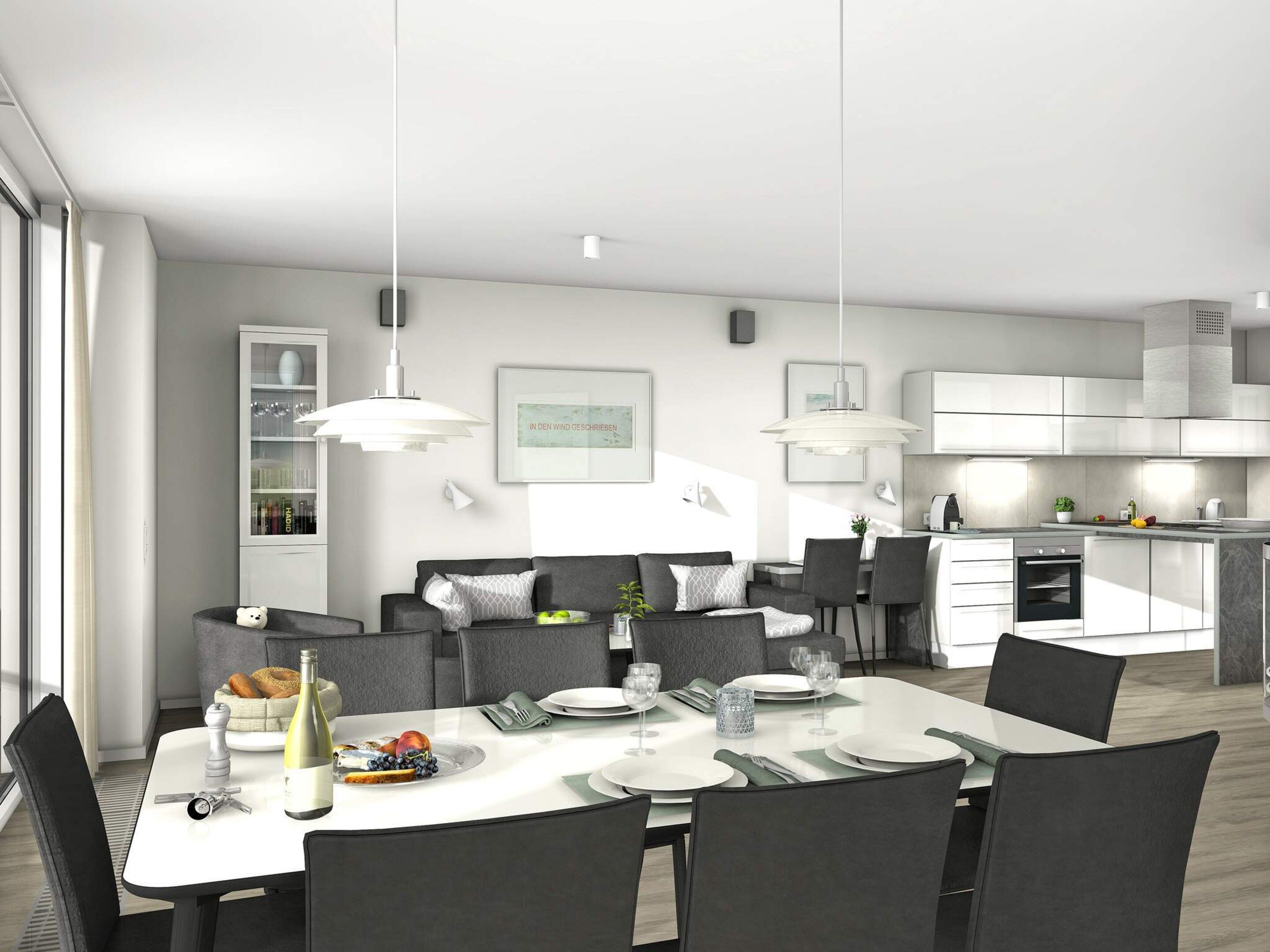 A modern dining area with a white table set for four, surrounded by dark chairs. A kitchen with white cabinets and a built-in oven is visible in the background.