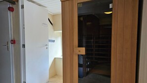 A room with a white door, a wooden-framed sliding door, and a tiled floor. - Renovated Holiday Home in Stavelot With Infrared Sauna (Stavelot)