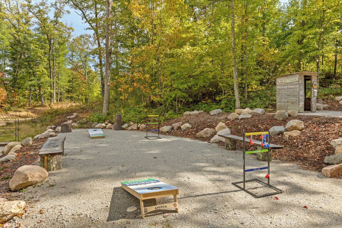 A campground with a wooden structure labeled "Fresh Pond" and a small pond.