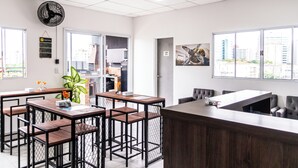 A modern office space with a reception desk, multiple seating areas, and large windows offering views of the cityscape.