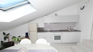 A compact kitchen with a skylight, a refrigerator, a microwave, and a sink. - LUANA One-Bedroom Apartment with Balcony (Rovinj)