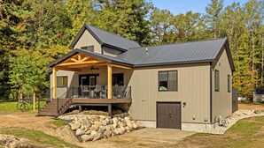 A modern two-story house with a covered porch and a garage. - Base Camp | Lookout Lodge #2 (Big Prairie Township)