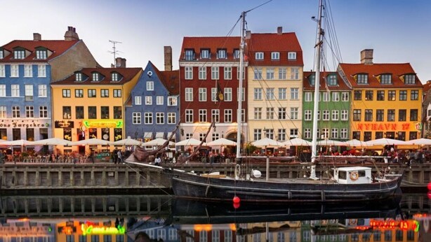 A harbor with colorful buildings and a boat docked in the water. - Agerup Comfortable Holiday Residence (Sakskobing)