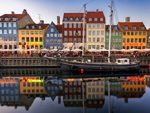 A harbor with colorful buildings and a boat docked in the water. - Agerup Comfortable Holiday Residence (Sakskobing)