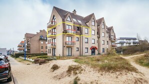 A multi-story residential building with a modern architectural design, featuring balconies and a prominent entrance. - Apartment Near Dunes in Koksijde (Koksijde)