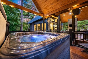 A hot tub with a wooden deck and a house in the background. - Family Favorite! Hot Tub, Game Room, Playset (Broken Bow)