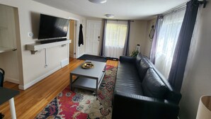 A living room with a sofa, television, and a coffee table.