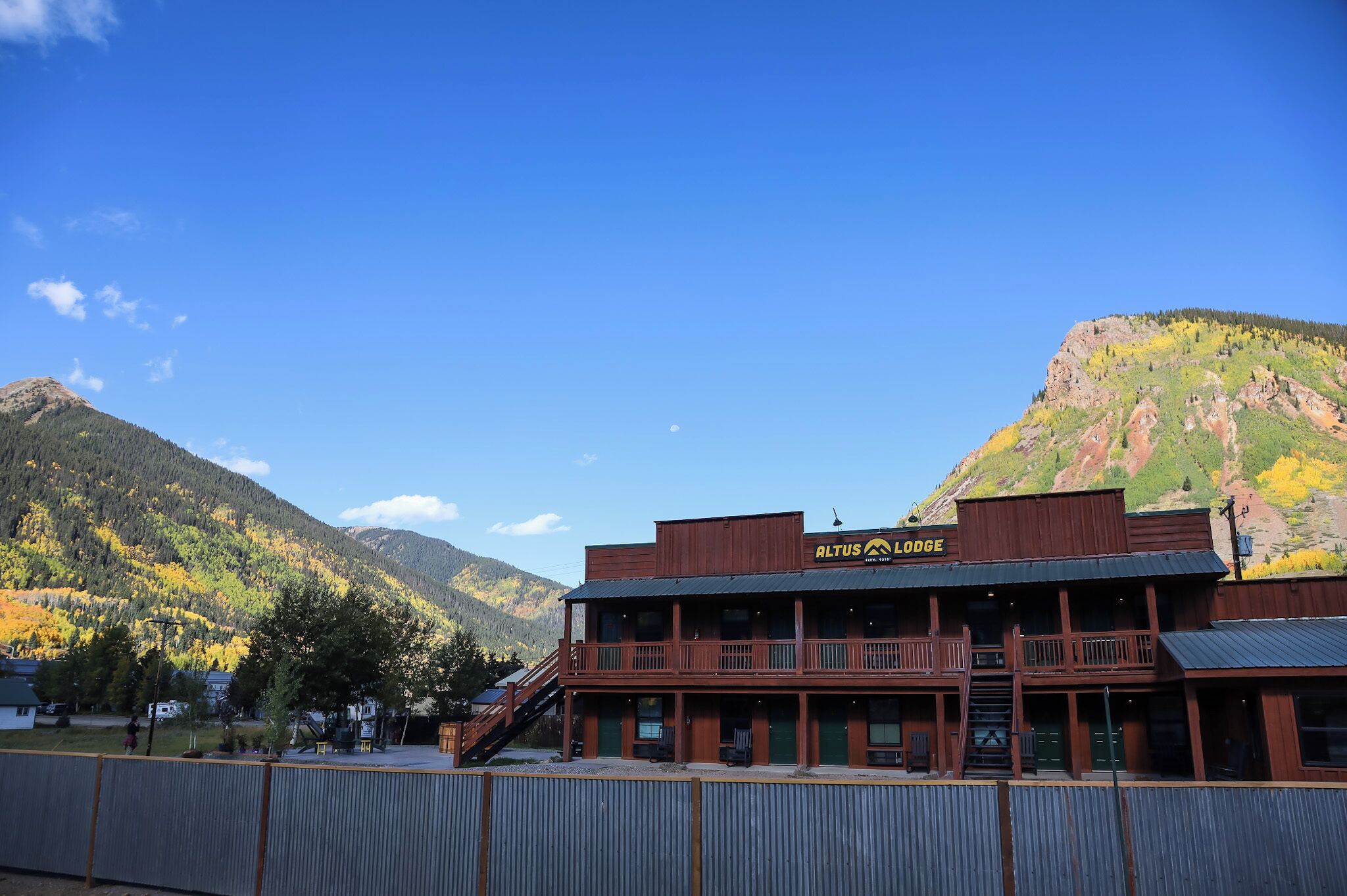 A two-story building with a sign reading "Altus Lodge." It features a balcony on the second floor and a staircase leading to the entrance.