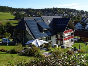 Situated in a lush green area, this house offers a clear view of the surrounding neighborhood.