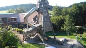 A unique building with a sloped roof and a large metal structure extending from it. - Holiday Apartment Kieschtock (Unterkirnach)