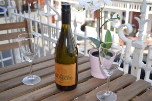 A bottle of wine and two glasses on a wooden table. - Pier12 (Eastbourne)