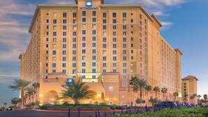 A large, multi-story hotel with a prominent 'WYNDHAM' sign at the top. - Wyndham Grand Desert 2 BR Deluxe - Full Resort Access -25% Deposit to Book NOW! (Las Vegas)