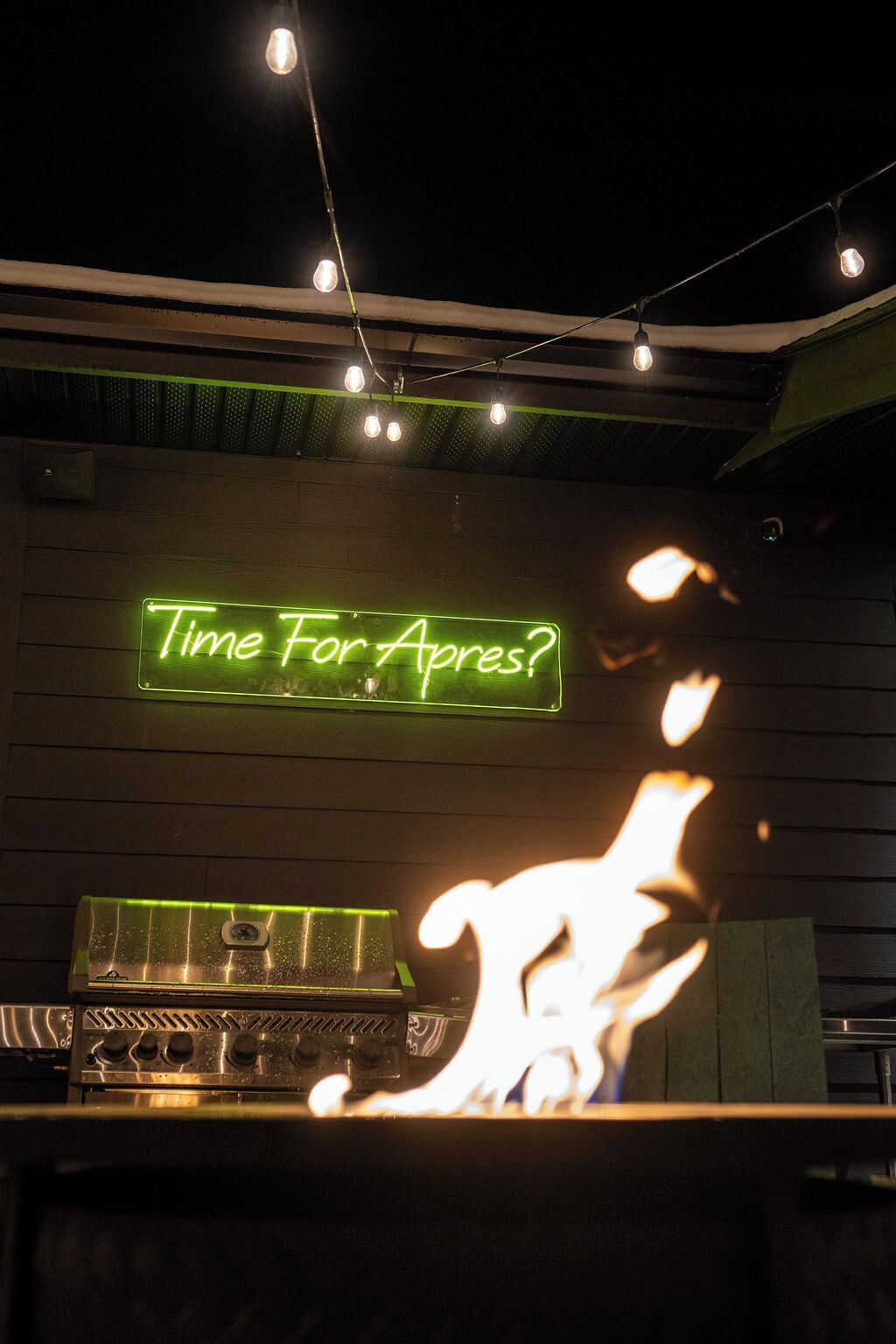 A neon sign reading "Time For Apart?" above a bar area with a grill and a neon light.