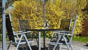 A metal-framed table with two chairs in an outdoor setting. - Black-headed Gull Comfortable Holiday Residence (Dranske)