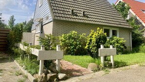 A house with a sloped roof, brick exterior, and a number '114' on the side. - Holiday House Viktoria at Lake Lauwersmeer (Anjum)