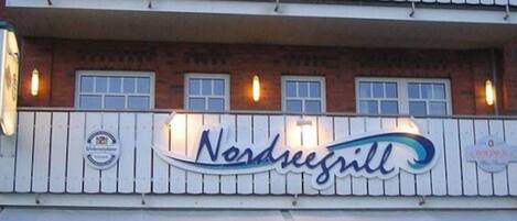 A two-story building with a sign reading "Nordseegill."