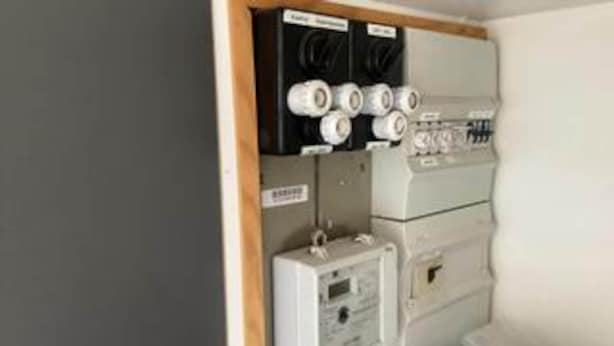 A utility room with electrical panels, a control panel, and labeled boxes. - 4 Person Holiday Home in Haderslev (Haderslev)