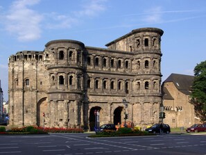 A historic stone building with multiple arches and towers, likely a castle or fortress. - Riesling Apartment on the Moselle Terrace (Detzem)