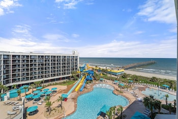 Indoor pool, seasonal outdoor pool, free cabanas, pool umbrellas at The Ellie Beach Resort Myrtle Beach, Tapestry By Hilton