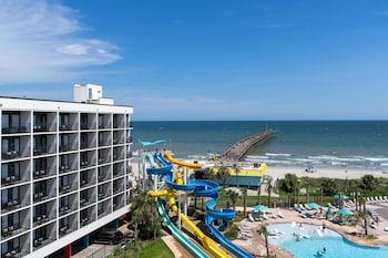 Indoor pool, seasonal outdoor pool, free cabanas, pool umbrellas at The Ellie Beach Resort Myrtle Beach, Tapestry By Hilton