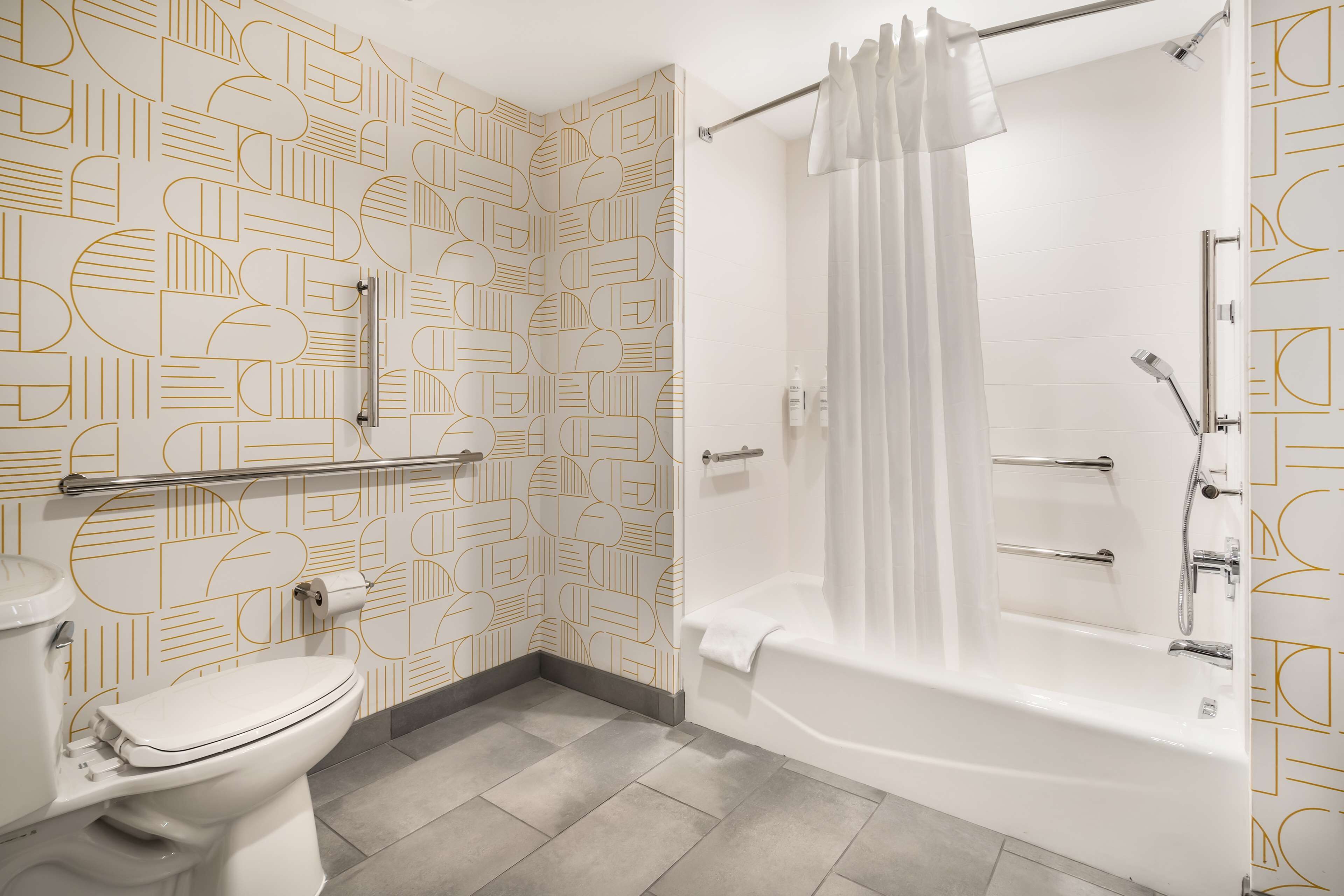 A bathroom with a toilet, a bathtub, and a shower.