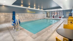 A modern indoor swimming pool with clear water, a lifeguard chair, and a sign that reads "POOLSIDE IS MY VIBE". - Home2 Suites By Hilton Reynoldsburg Columbus East (Reynoldsburg)
