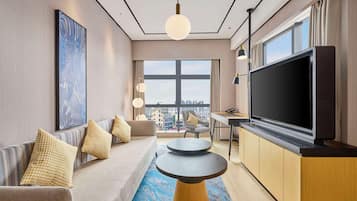 Deluxe Suite, 1 King Bed | Living area | 55-inch TV with cable channels