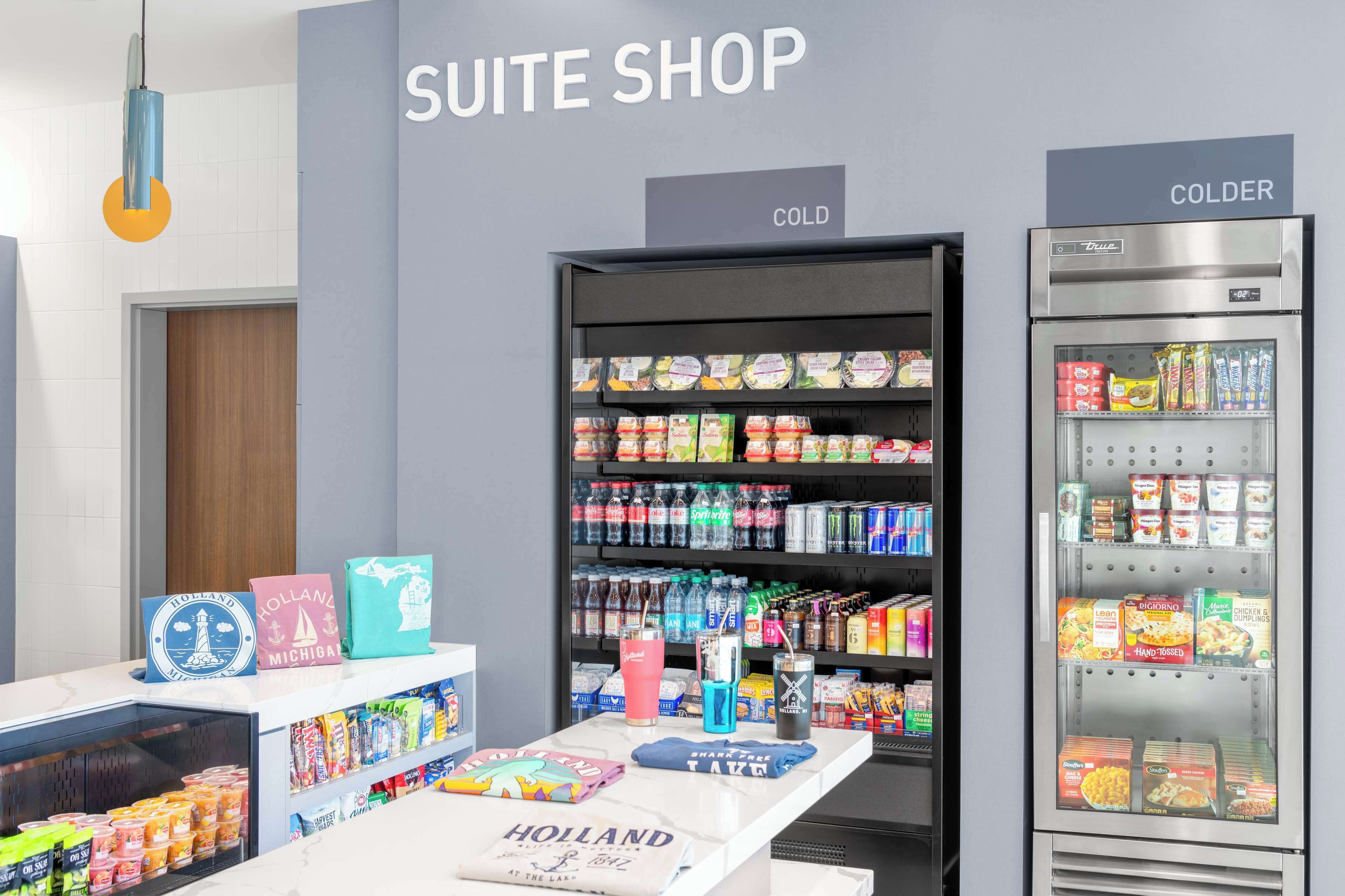 A suite shop with refrigerated display cases labeled "COLD" and "COLDER" containing various food items.