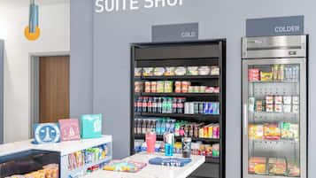 A suite shop with refrigerated display cases labeled "COLD" and "COLDER" containing various food items.