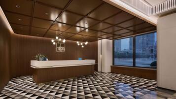 A modern reception area with a geometric patterned floor, a reception desk, and a large window offering a view of the cityscape.