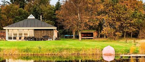 A lakeside property with a wooden building, a dock, and a picnic area.