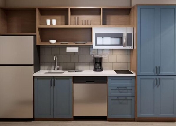A modern kitchen with a built-in microwave, a coffee maker, and a sink. - Candlewood Suites Pittston by IHG (Pittston)