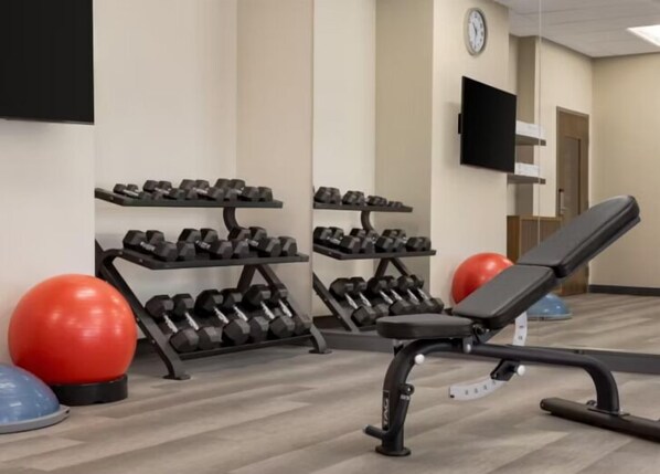 A gym with weightlifting equipment, exercise balls, and a bench. - Candlewood Suites Pittston by IHG (Pittston)