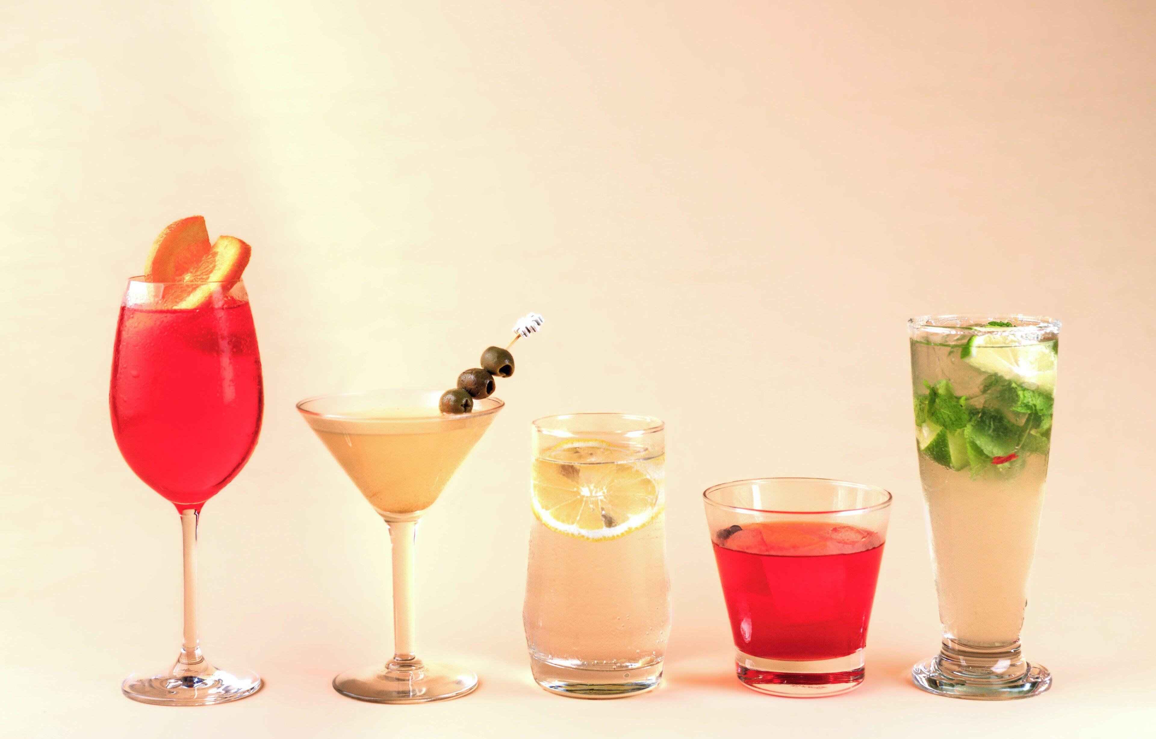 Five different types of drinks in various glassware.