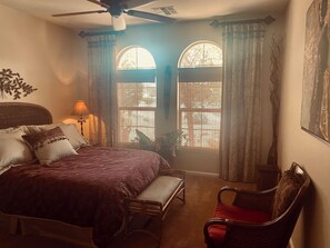 A bedroom with a bed, a chair, a ceiling fan, and two windows with curtains. - GORGEOUS Green Valley AZ house & pool in QC GolfResortSUMMER MONTHLY RENTAL ONLY (Green Valley)