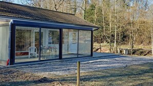 A modern house with large glass windows and a tiled roof. - Nature Retreat by the Lakes (Florennes)