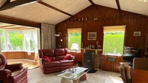 Una sala de estar acogedora con un sofá de cuero, una mesa de centro y una chimenea.